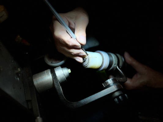 A jeweler sets diamonds on a Rolex bezel, highlighting precision in luxury watch customization. Ideal for customers interested in bespoke watch enhancements.